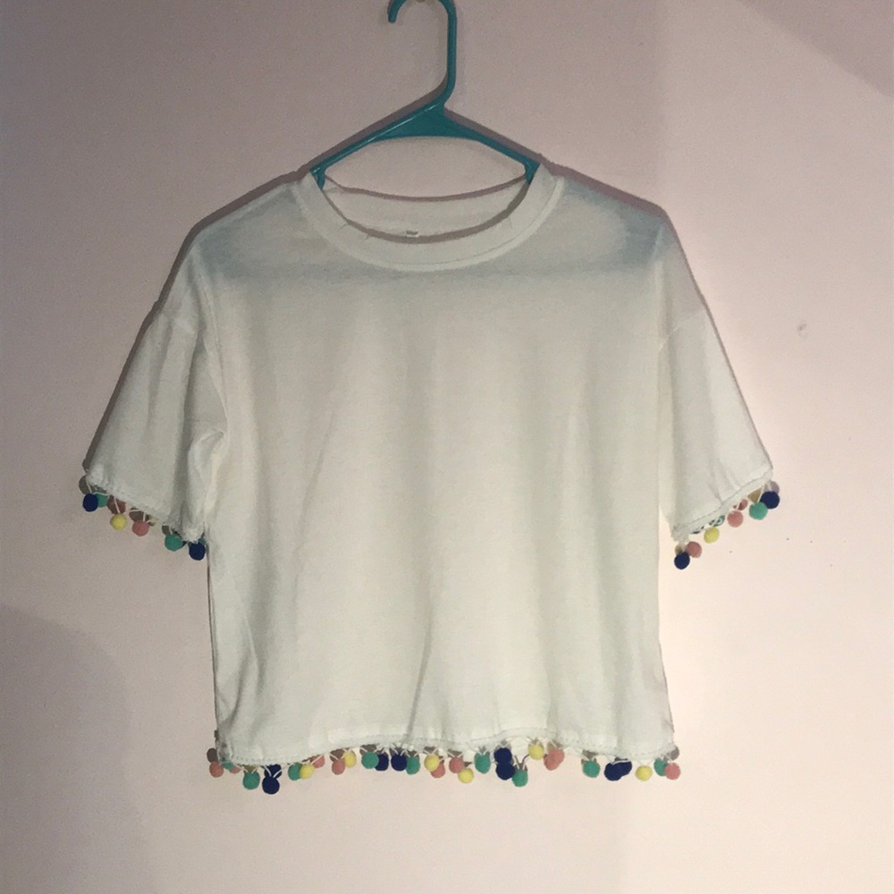 White Tee with multicolor Pom Pom details.